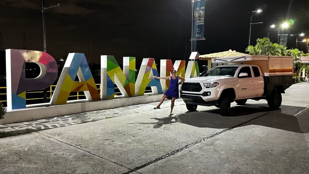 Hi From Ashley with her toyota Tacoma in front of the Panama Sign